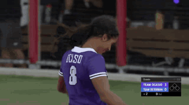 a soccer player wearing a purple jersey with the number 8 on it