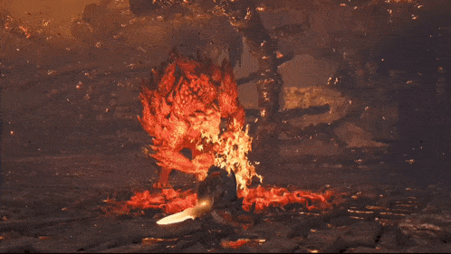 a person is standing in front of a large fire