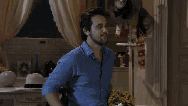 a man is giving flowers to a woman sitting on a bed