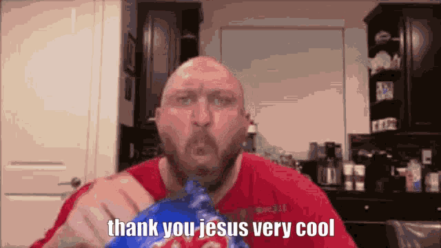 a bald man is eating a bag of potato chips and saying thank you jesus very cool