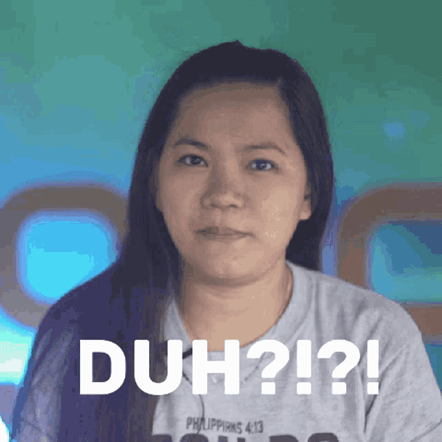 a woman wearing a philippians 4:13 shirt is making a funny face