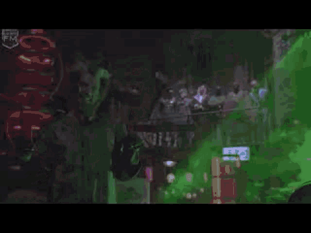 a man in a red hat is standing in front of a green smoke coming out of a building .