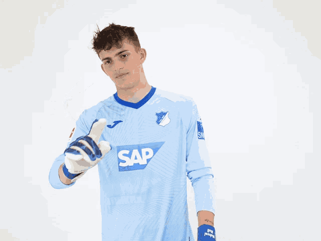 a man wearing a blue shirt with the word sap on the front