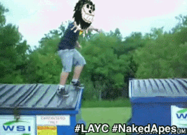 a man is doing a trick on top of a dumpster with the hashtag #layc on the bottom
