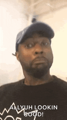 a man with a beard and a hat is making a funny face .