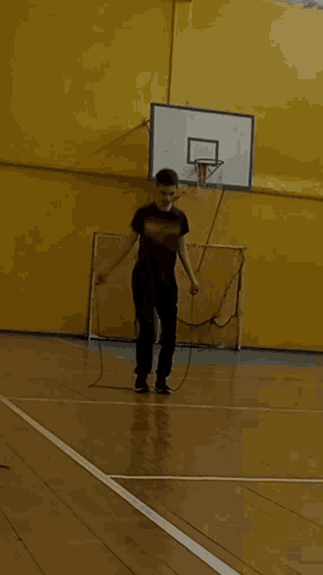 a man in a superhero shirt is playing a game of basketball