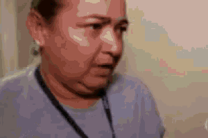 a close up of a woman wearing a lanyard around her neck and a stethoscope around her neck .