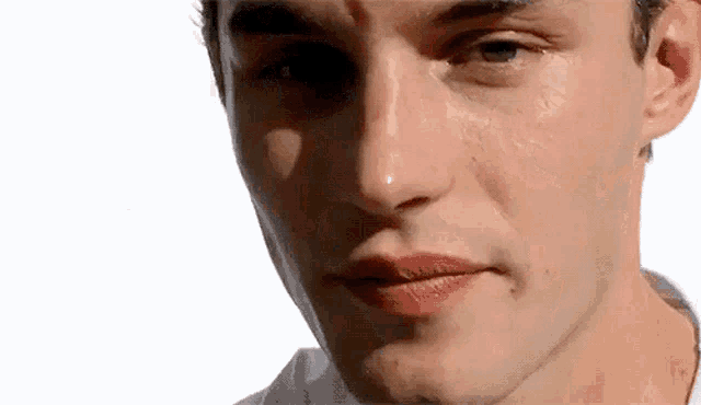 a close up of a man 's face with his eyes closed and his mouth open .