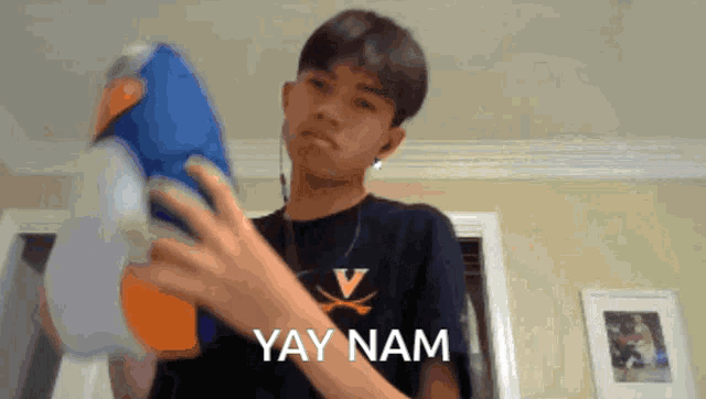 a young man wearing a shirt that says v on it