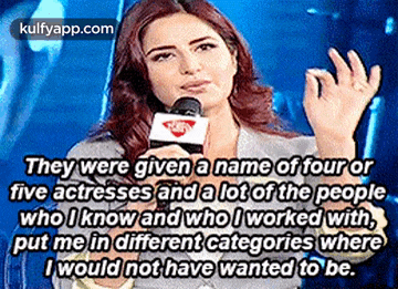 a woman is talking into a microphone and says they were given a name of four or five actresses