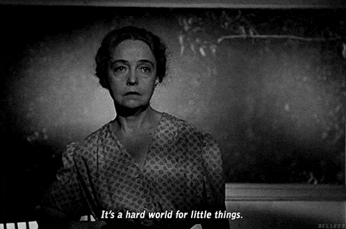 a black and white photo of a woman with the caption it 's a hard world for little things