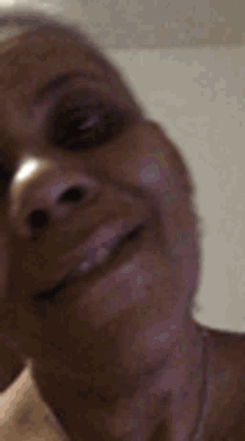 a close up of a woman 's face with a smile on it .