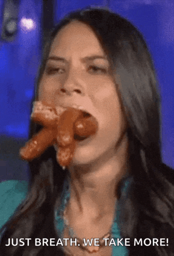 a woman is eating a sausage with the words just breath we take more below her