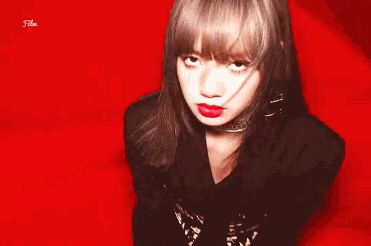 a close up of a woman 's face on a red background with the word film below her