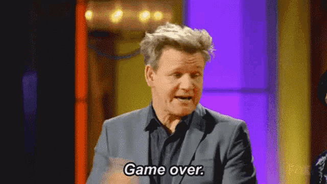 a man in a suit says game over on a purple background