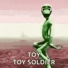 a green alien is sitting on a rock in the desert and says `` toy toy soldier '' .