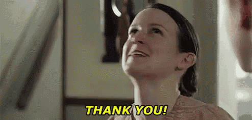 a woman is smiling and saying thank you while looking up .