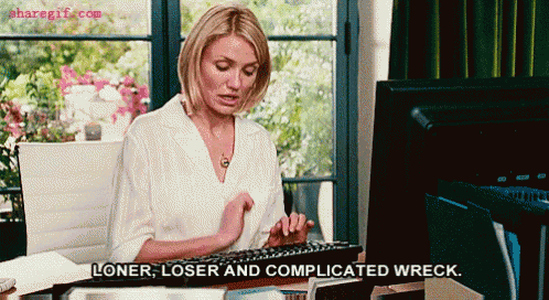 a woman sits at a desk typing on a keyboard with the words loner loser and complicated wreck below her
