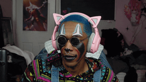 a man wearing pink headphones and a clown face painted on his face