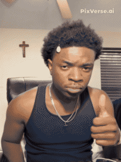 a man is giving a thumbs up in front of a cross on the wall
