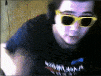 a man wearing sunglasses and headphones is wearing a shirt that says ninja