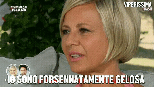 a woman sitting on a couch with temptation island on the bottom