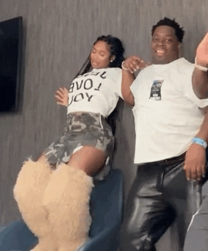 a man and a woman are dancing in a room .