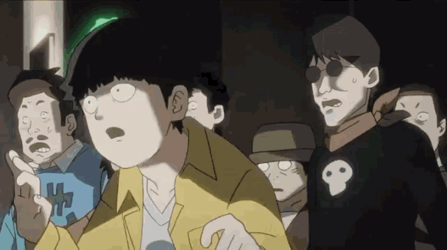 a man with a skull on his shirt is surrounded by other people