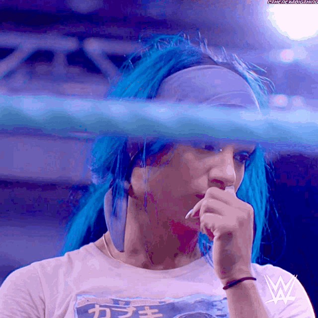 a woman with blue hair is wearing a t-shirt that says " tokyo " on it