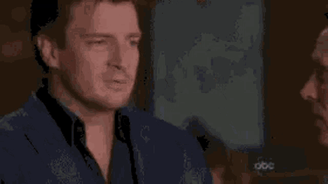 a man wearing sunglasses is making a funny face in front of the words `` castle monday '' .