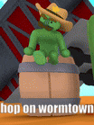a green cartoon character wearing a cowboy hat is sitting on top of a barrel .