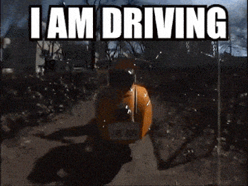 a scooter is driving down a dirt road with the words `` i am driving '' written on the bottom .