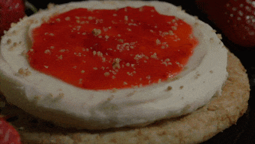 a cookie with strawberry jam on top of it