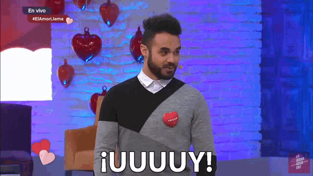 a man wearing a sweater that says iuuuuy on it