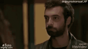 a man with a beard is looking at another man with a beard .