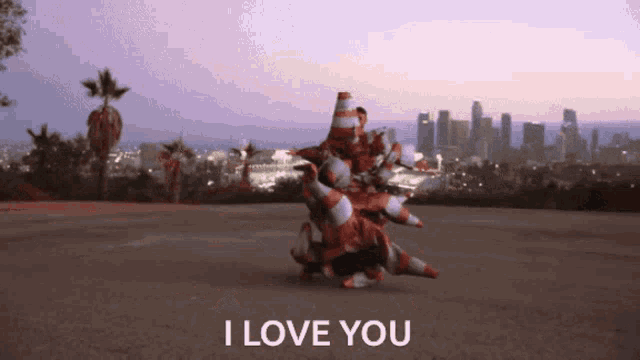a bunch of traffic cones are stacked on top of each other with the words " i love you " above them
