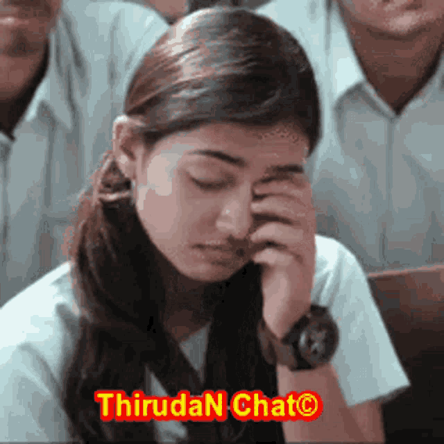 a girl with a watch on her wrist is crying in front of a group of people and a sign that says thiruda chat