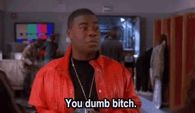 a man in a red jacket is saying `` you dumb bitch '' in a room .
