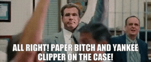 a man in a suit and tie is raising his hands in the air while another man says all right !