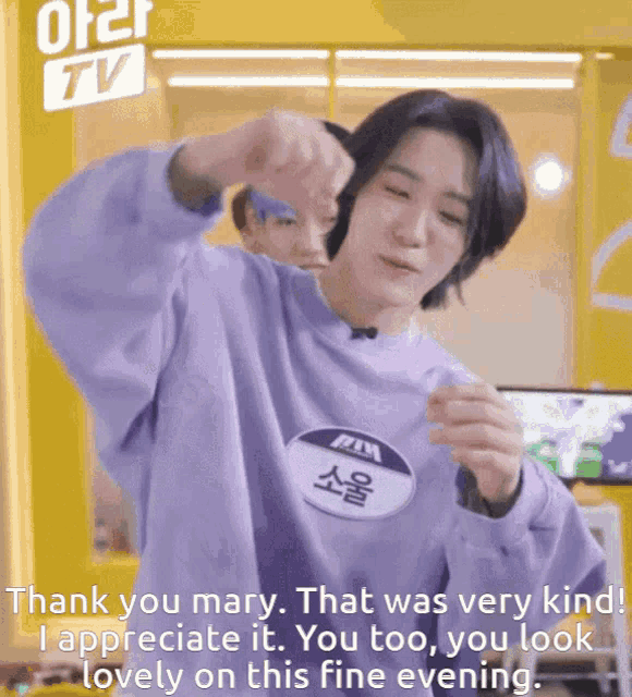 a man wearing a purple sweatshirt with a name tag that says " mary "