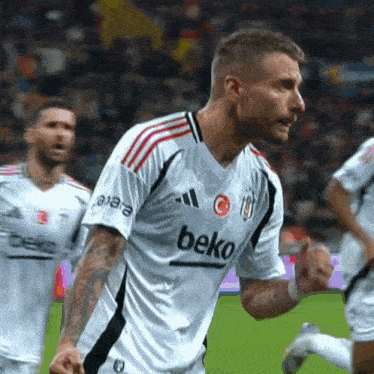 a soccer player wearing a beko jersey celebrates