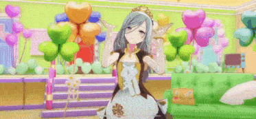 a girl with long hair and a crown on her head is standing in front of balloons and giving a thumbs up .
