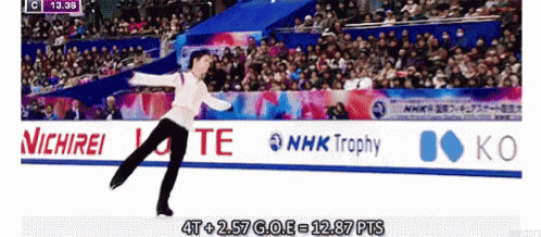 a man is ice skating in front of a nhk trophy sign