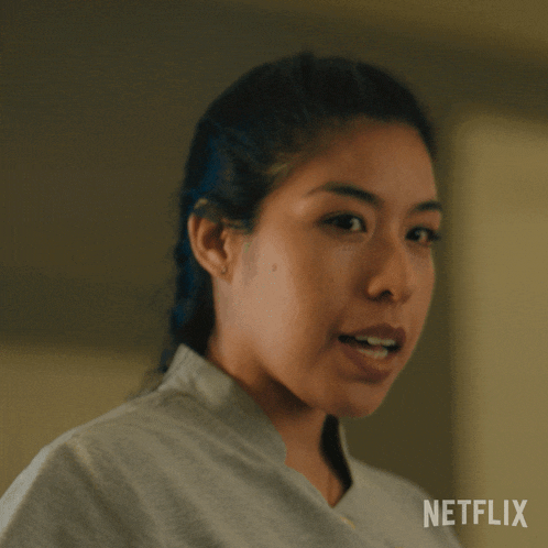 a close up of a woman 's face with a netflix logo behind her