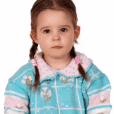 a little girl with pigtails wearing a blue dress
