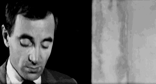 a black and white photo of a man with his eyes closed .