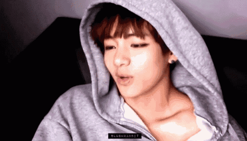 a close up of a person wearing a hoodie .