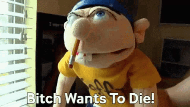 a puppet with a pencil in his mouth and the words " bitch wants to die "