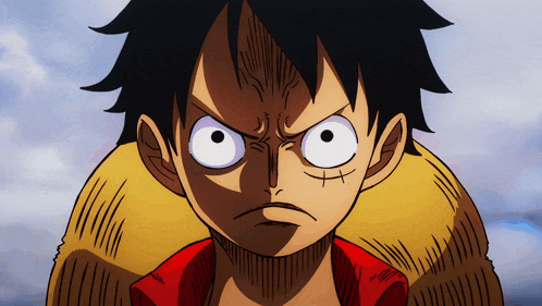 a close up of a cartoon character 's face with big eyes and a red shirt