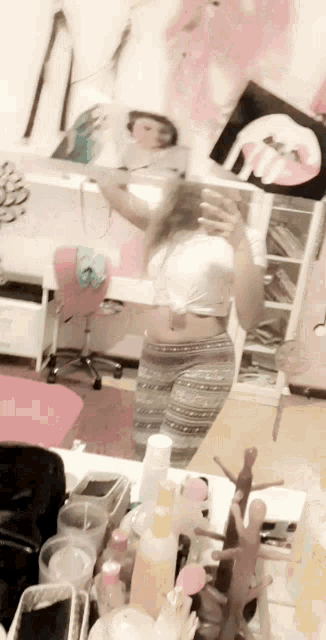 a woman taking a picture of herself in a mirror in a room